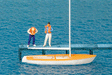 Korsar Sailboat w/2 Sailors Putting On Life Jackets -- Sails Down (white, yellow)