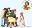 Woman in Chair Reading Aloud to Boy and Girl