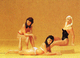 Women on Beach -- 2 Sitting & 1 Lying Down