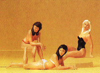 Women on Beach -- 2 Sitting & 1 Lying Down